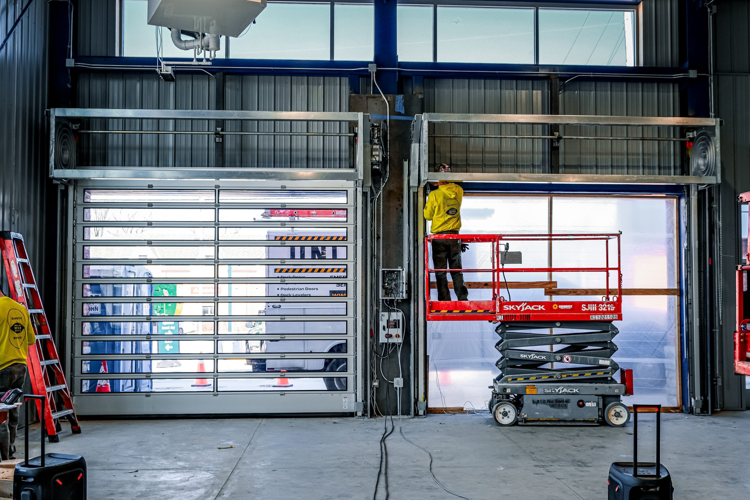 United Door and Dock Technician installing Hormann High Performance Doors at Delta Sonic Car Wash